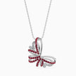 Butterfly-shaped pendant with red stones on a white background