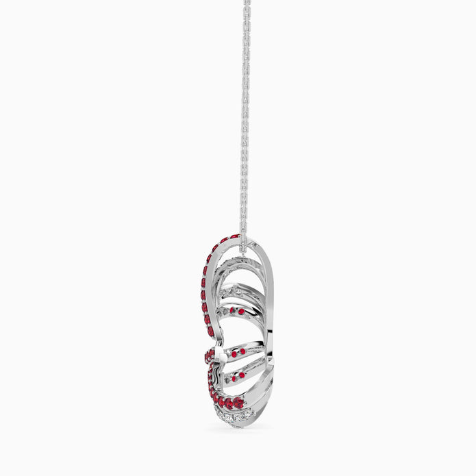 Silver pendant with red gemstones on a white background